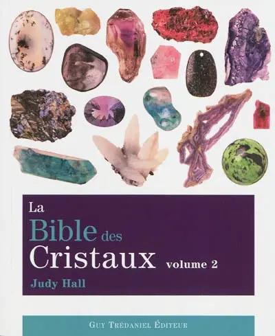 Livre La Bible des Cristaux Volume 2, livre imprimé à couverture violette avec collage de cristaux colorés