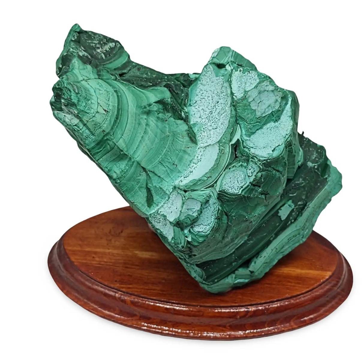 Malachite mineral specimen on a wooden stand against a white background