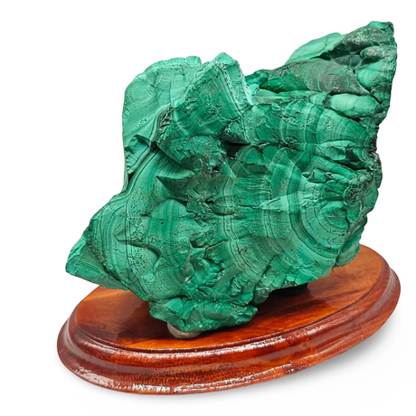 Natural malachite stone specimen on a wooden display base