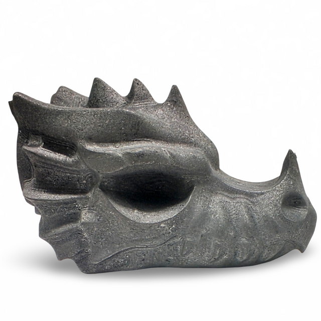 Shungite dragon head sculpture on a white background